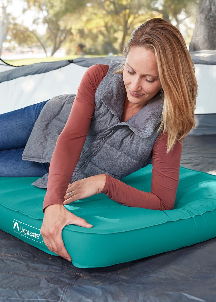 Woman using Lightspeed air mattress while camping