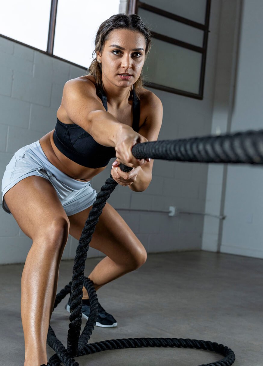 Woman pulling battle rope