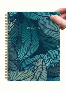 person holding up planner notebook
