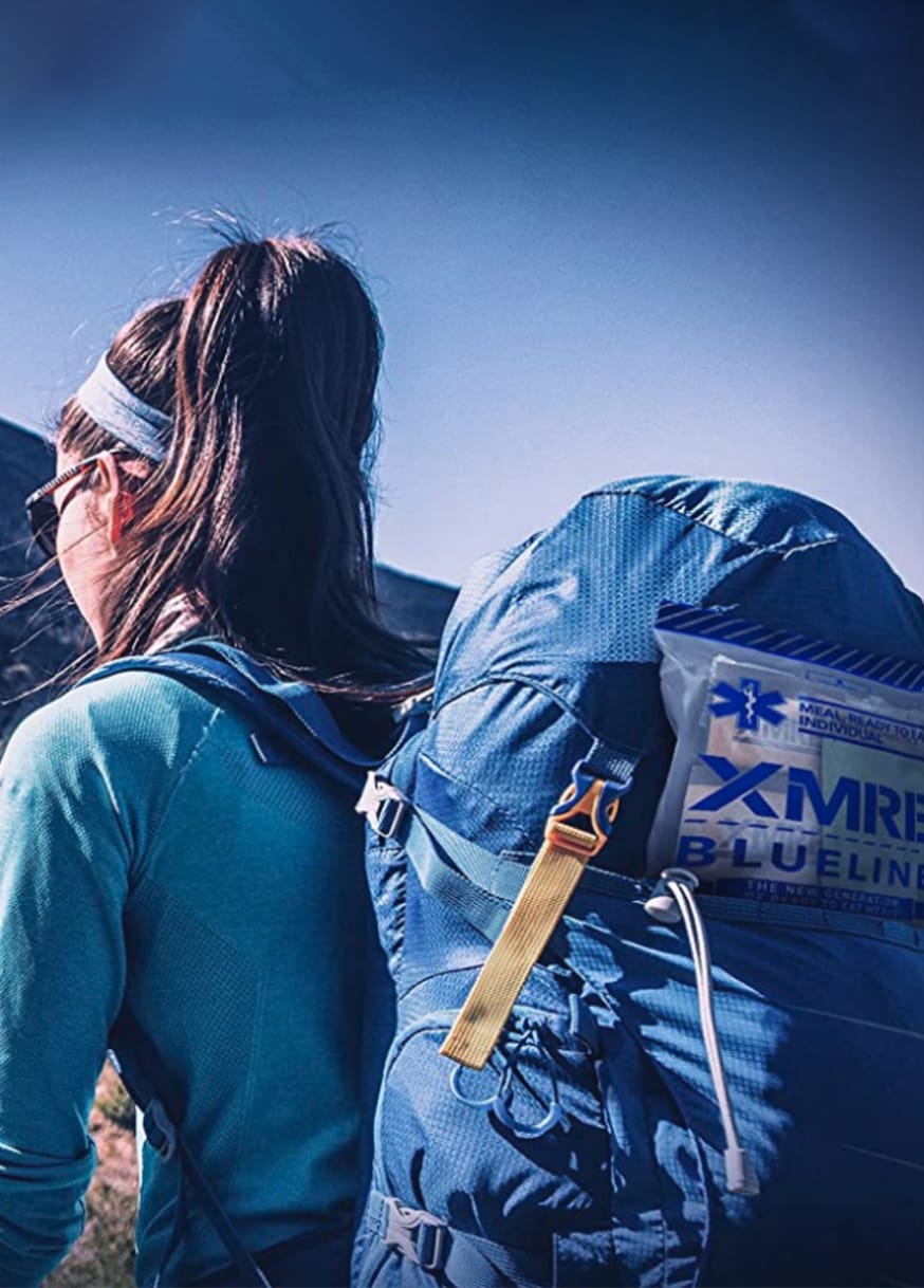 Woman hiking with XMRE meal in backpack